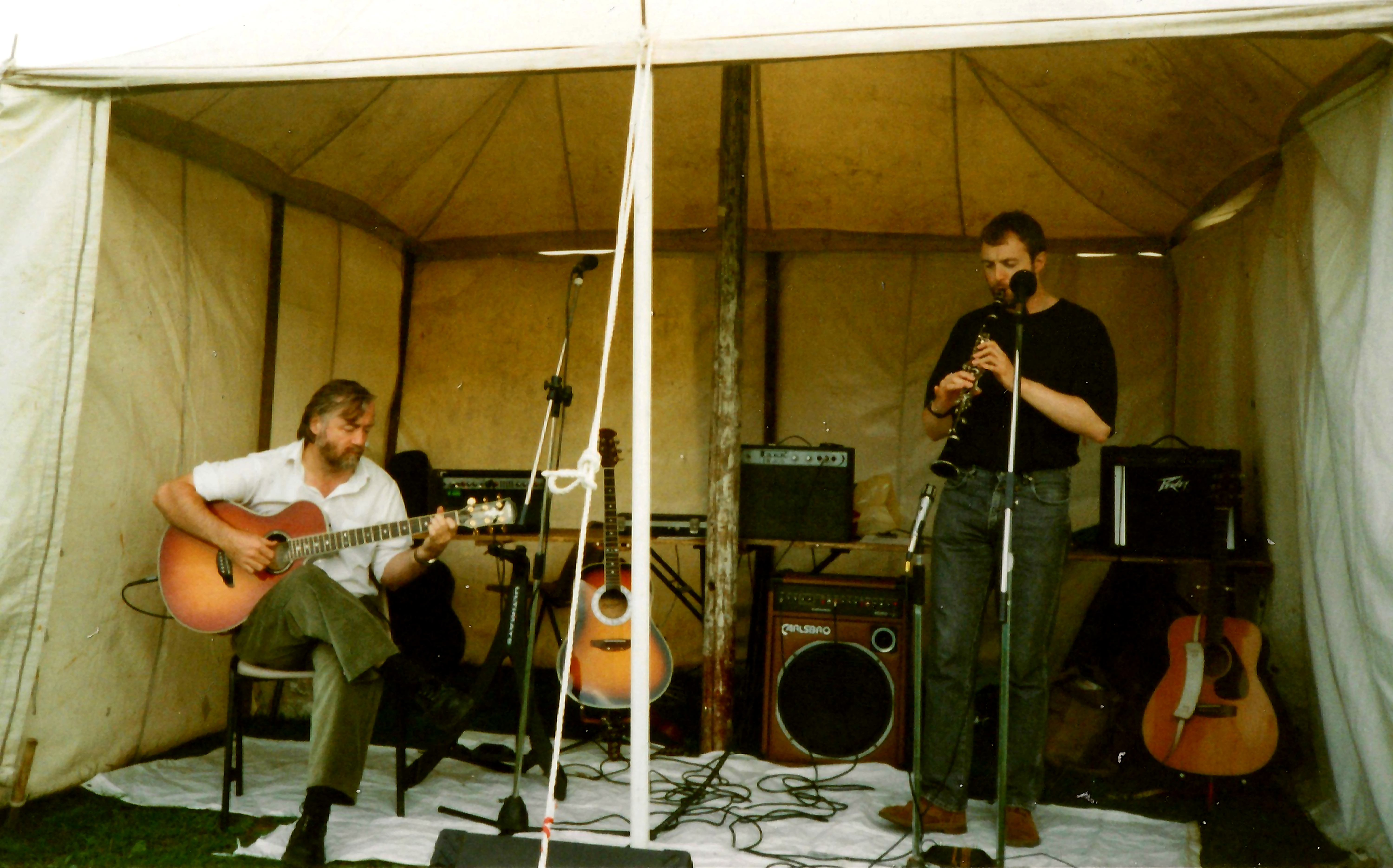 Steve McWilliam playing acoustic guitar while Ian Jesse plays clarinet at Spike Island in 1995