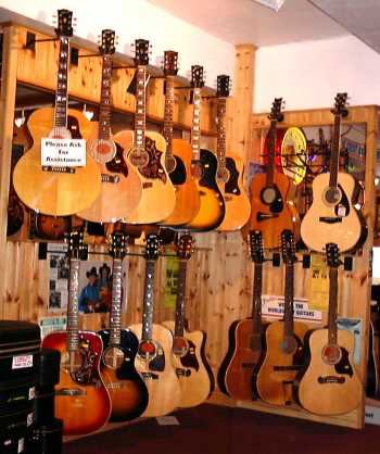 One small area of acoustic guitars within Frailers Vintage Guitar and Banjo Shop